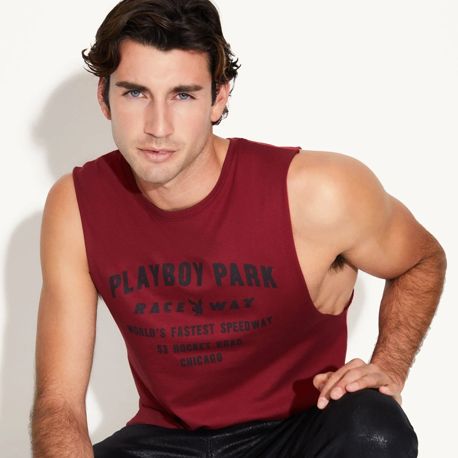 Man wearing maroon sleeveless muscle tank with Playboy Park Raceway graphic text.