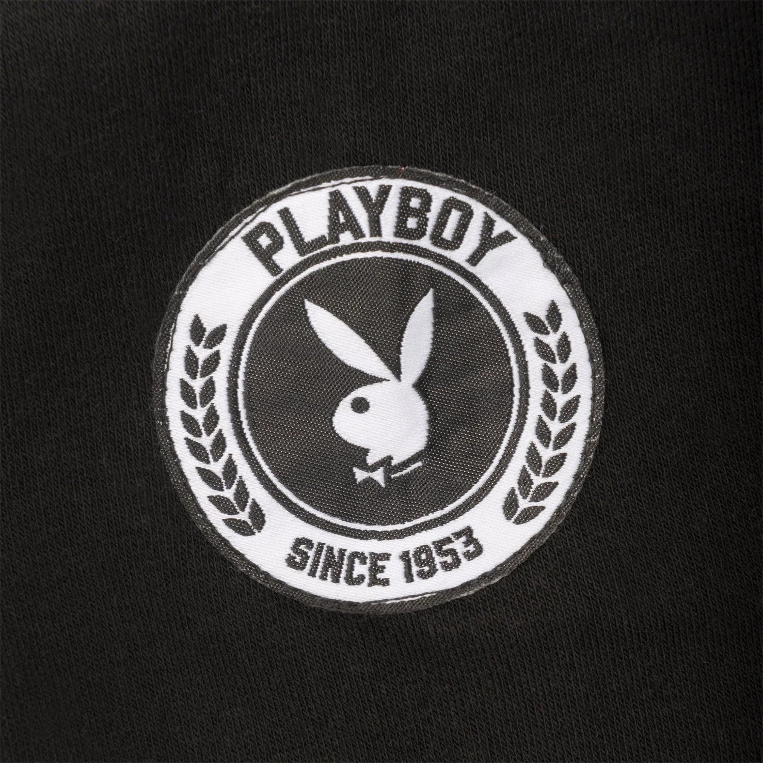 Black crewneck sweatshirt with embroidered white Playboy bunny logo and laurel crest patch