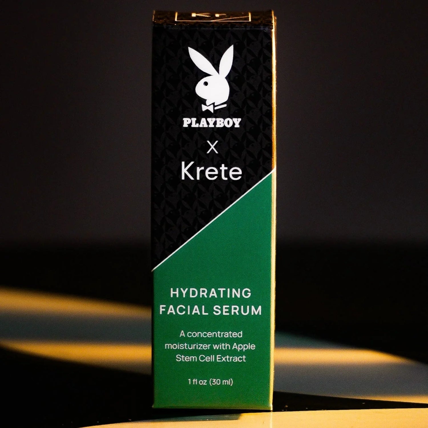 Hydrating facial serum box with apple stem cell extract, black and green packaging