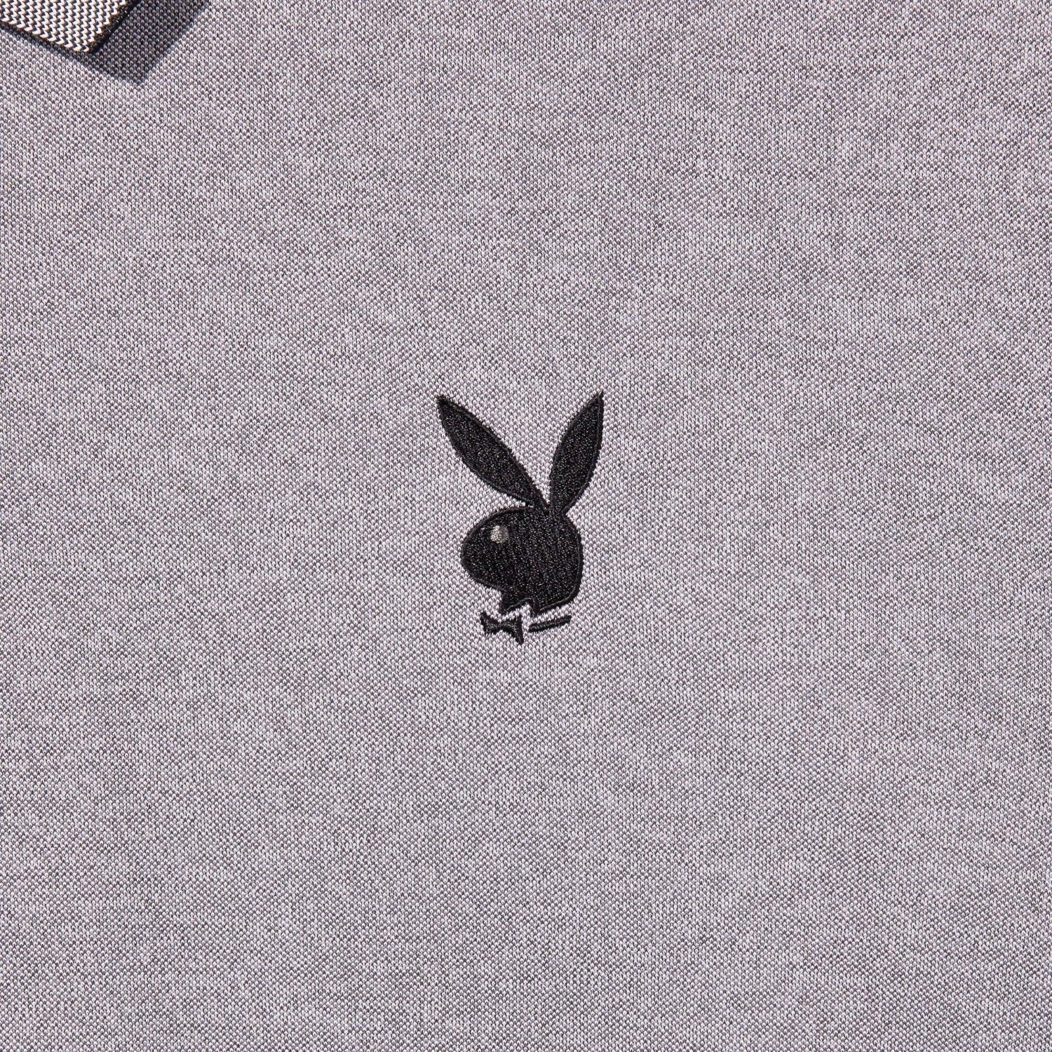 Gray golf polo shirt with a black rabbit head logo embroidery and tipped collar detail