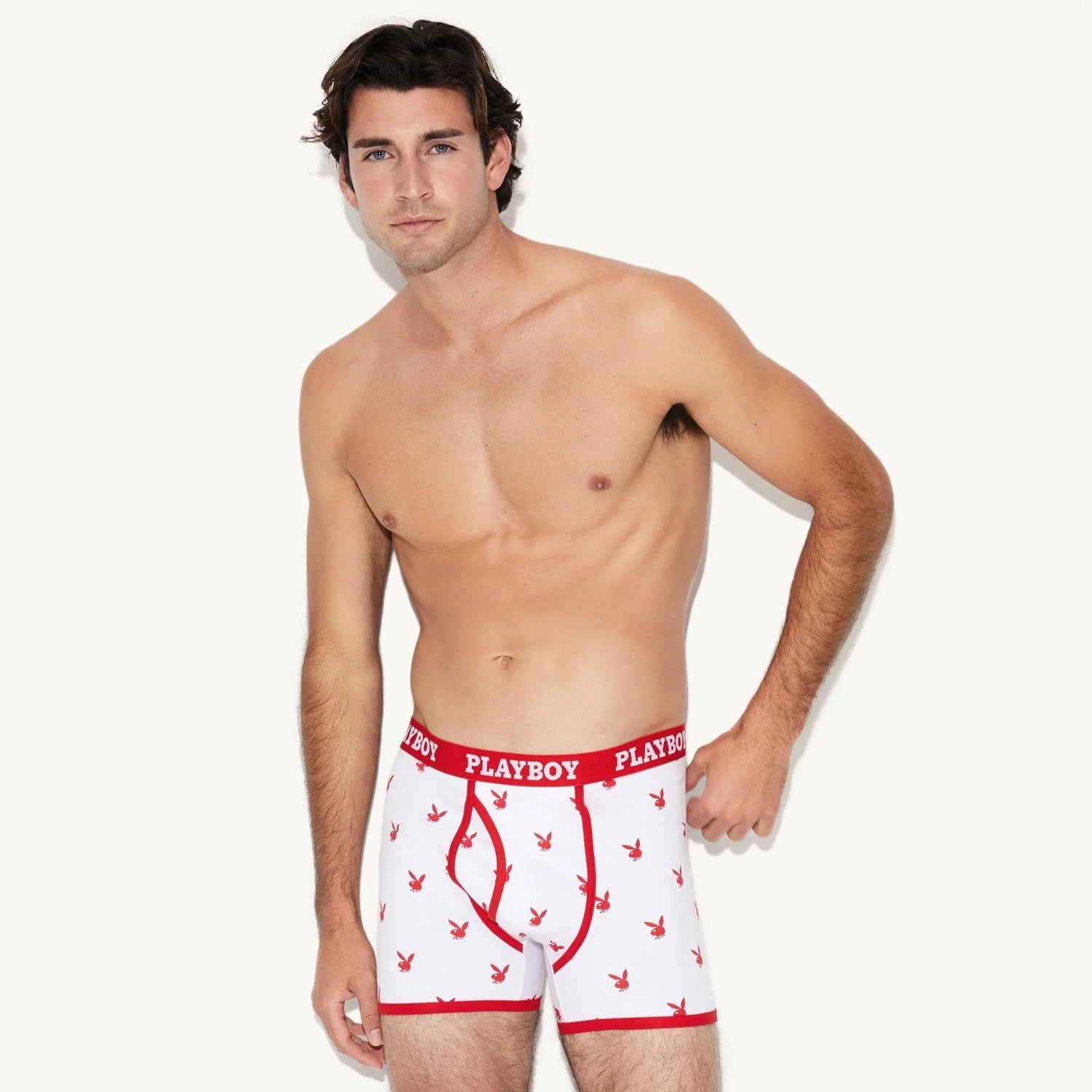 Man modeling white boxer briefs with red rabbit head pattern and red waistband with visible logo