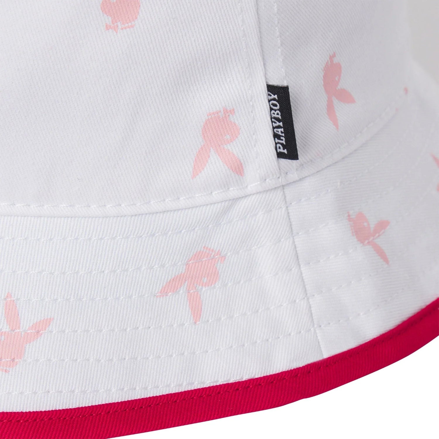 White bucket hat with pink rabbit head print and red brim detail, close-up view