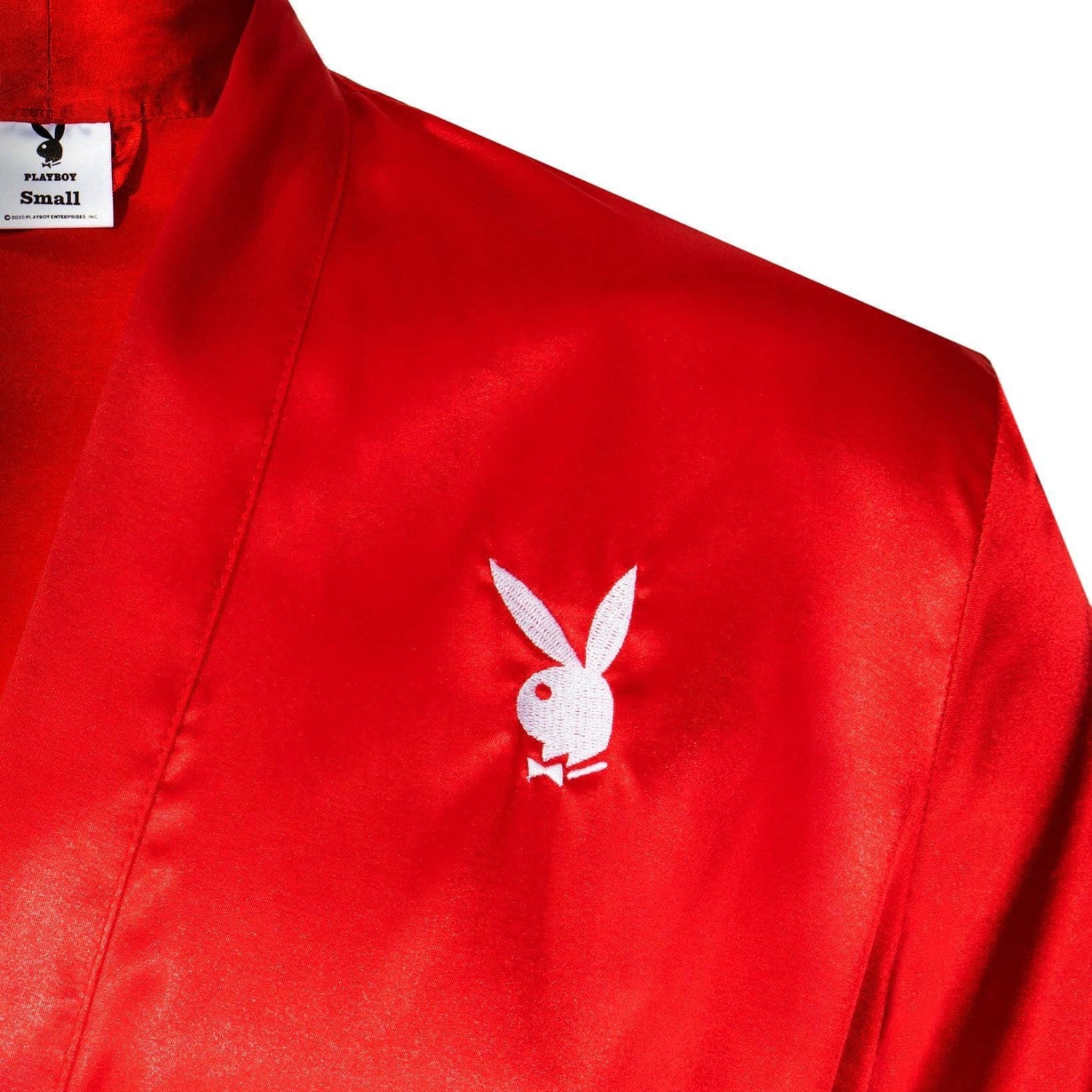 Red satin robe with white bunny logo embroidery on chest, luxury loungewear close-up