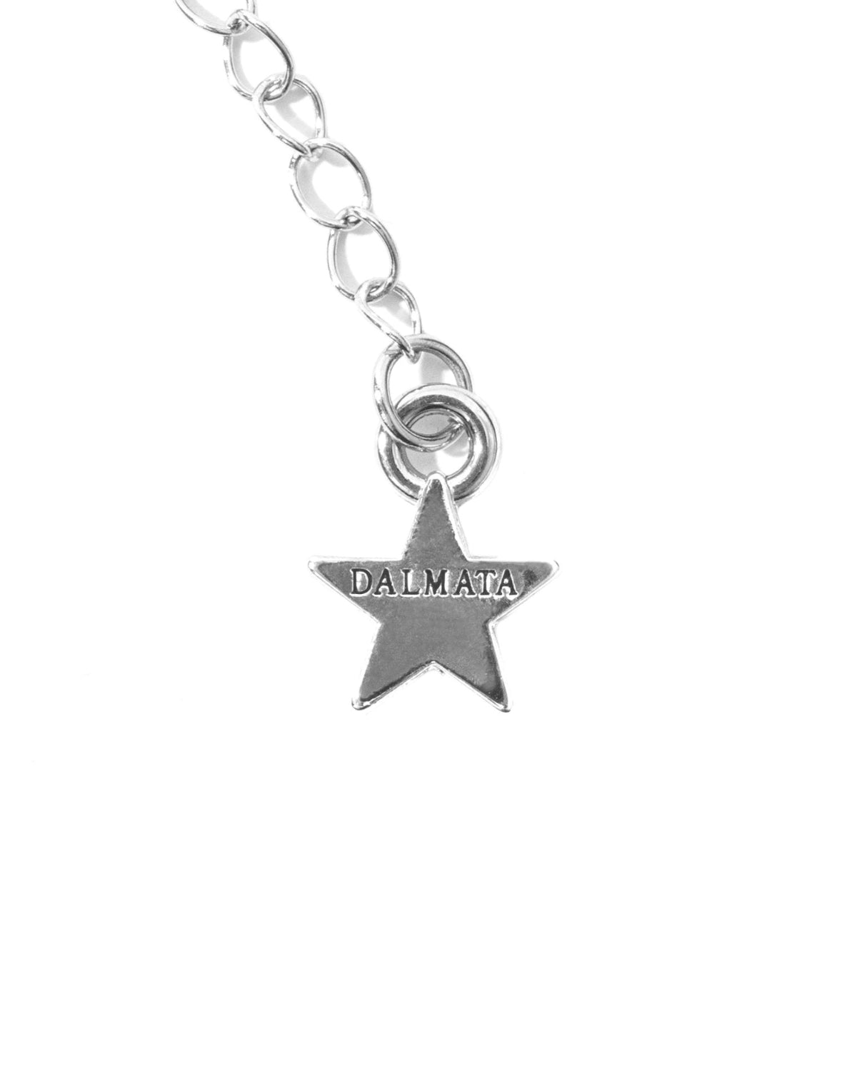 Silver star charm with 'DALMATA' engraving on chain, jewelry detail on white background