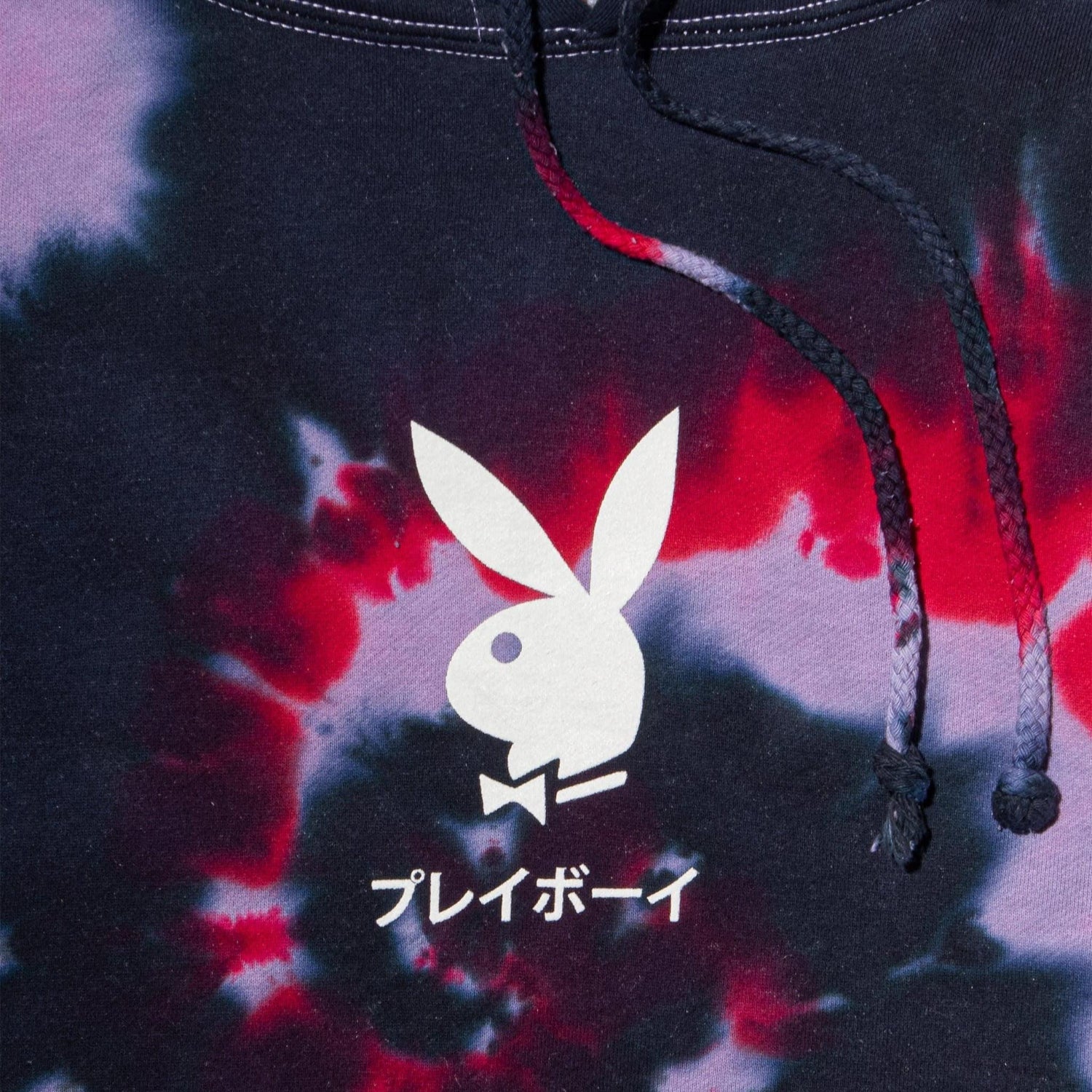 Black and red tie-dye hoodie with white bunny logo and Japanese text on the front
