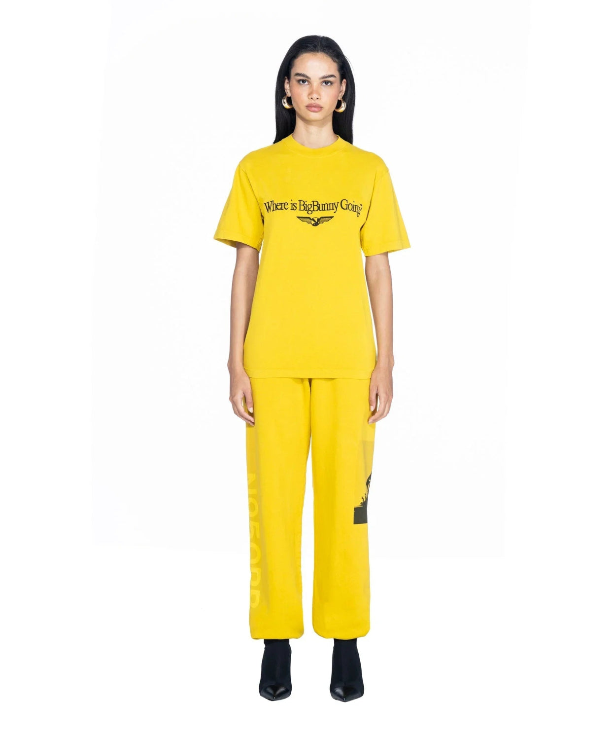 Woman wearing yellow graphic t-shirt with 'Where is BigBunny Going?' text and matching pants