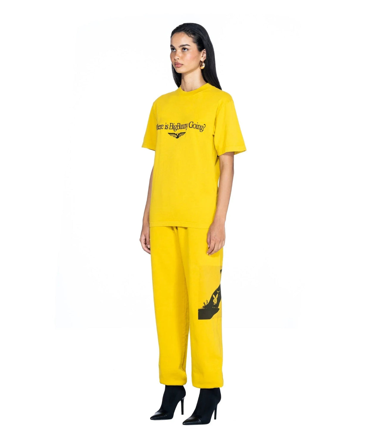 Woman wearing yellow graphic t-shirt with 'Where is BigBunny Going?' text and matching pants