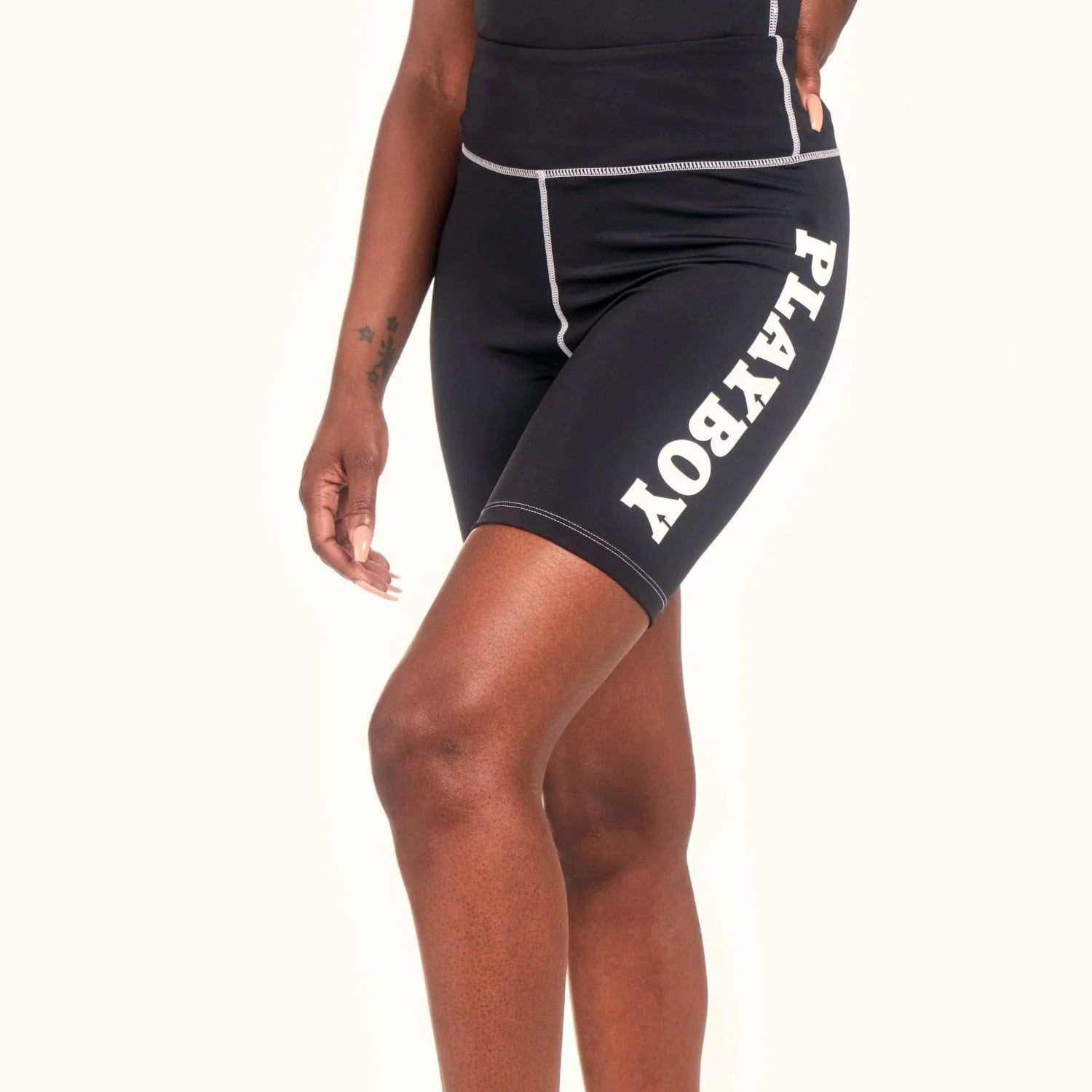 Black women's active bike shorts with high waist and white logo text on the leg.