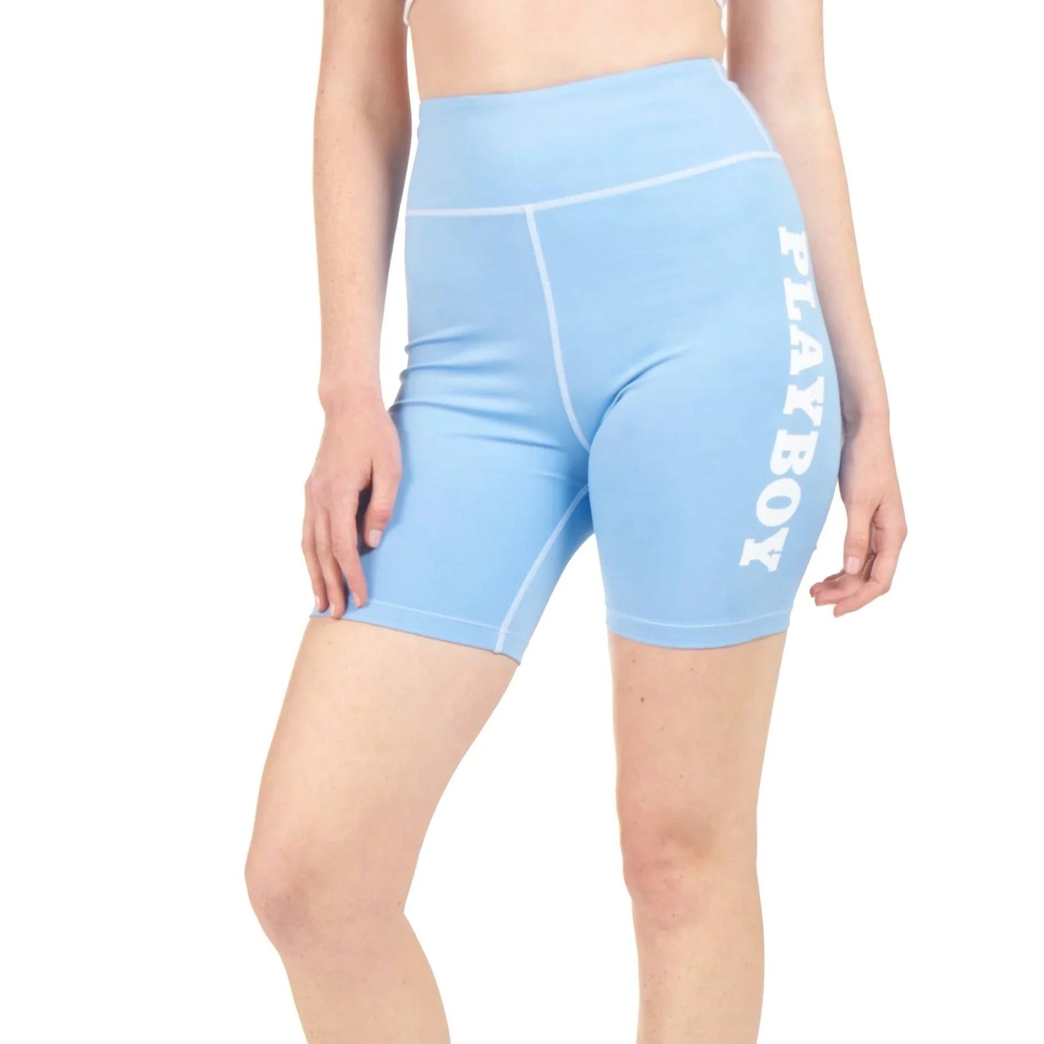Woman wearing light blue high-waisted bike shorts with PLAYBOY text on the side