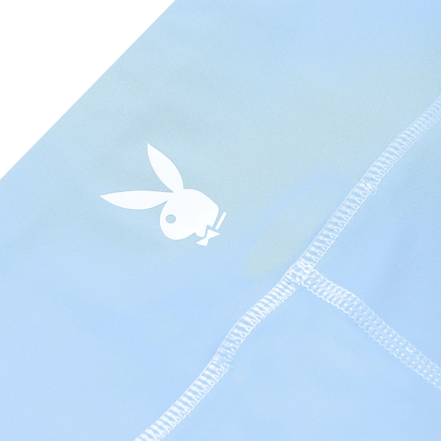 Close-up of light blue women's active bike shorts with bunny logo and visible stitching