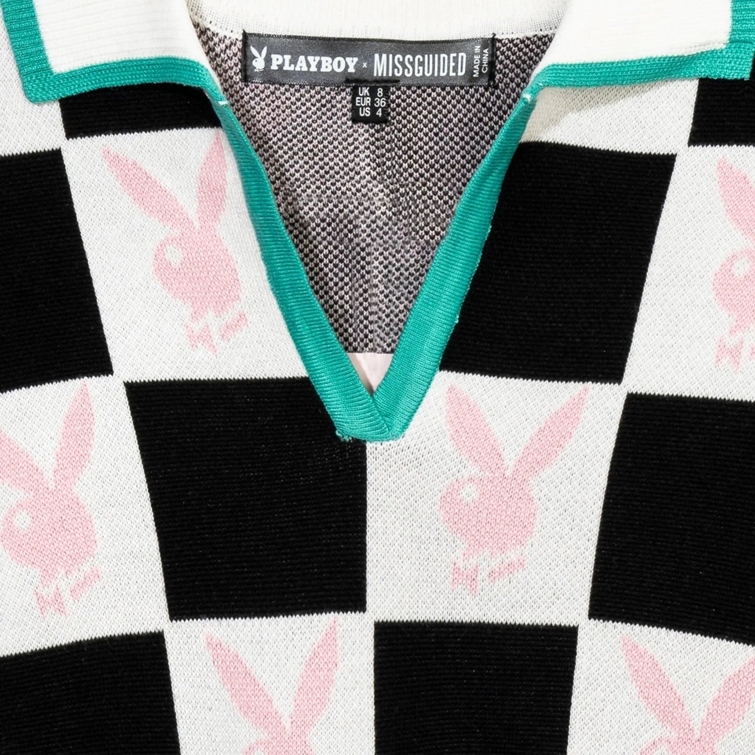 Women's checkerboard top with black and white squares, pink bunny logos, and green trim collar.