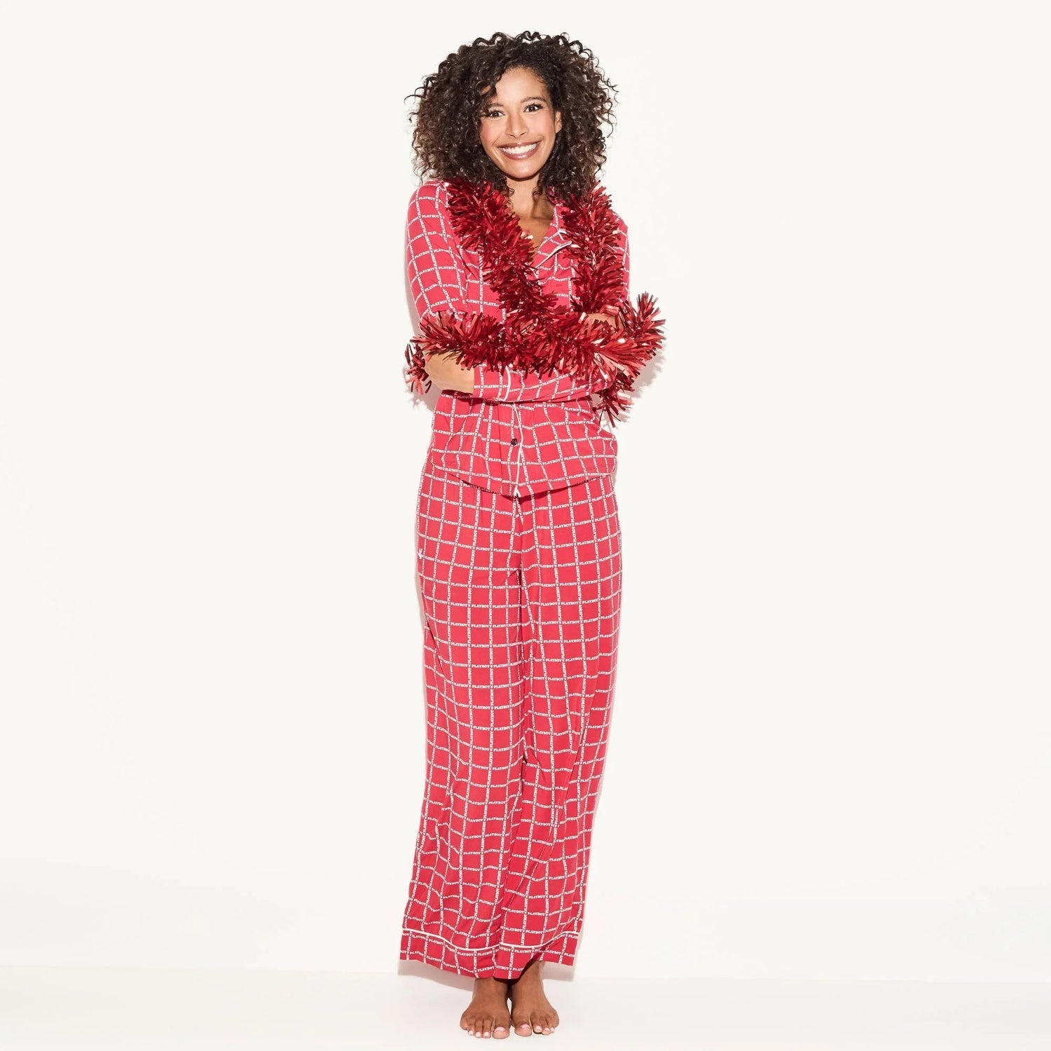 Woman wearing red checkered classic sleep set pajama with festive garland