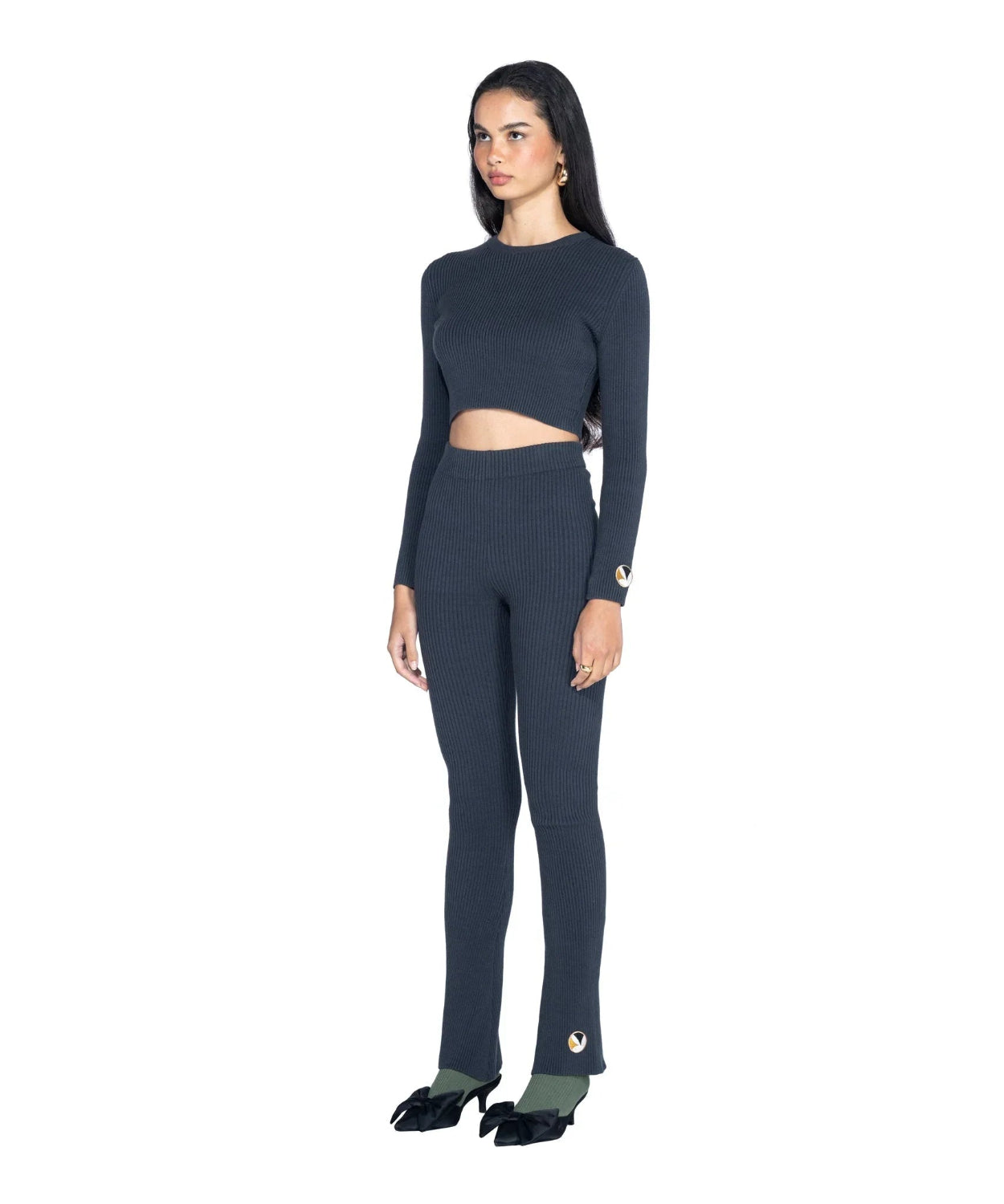 Woman wearing ribbed long sleeve cropped top and matching high-waisted pants set.