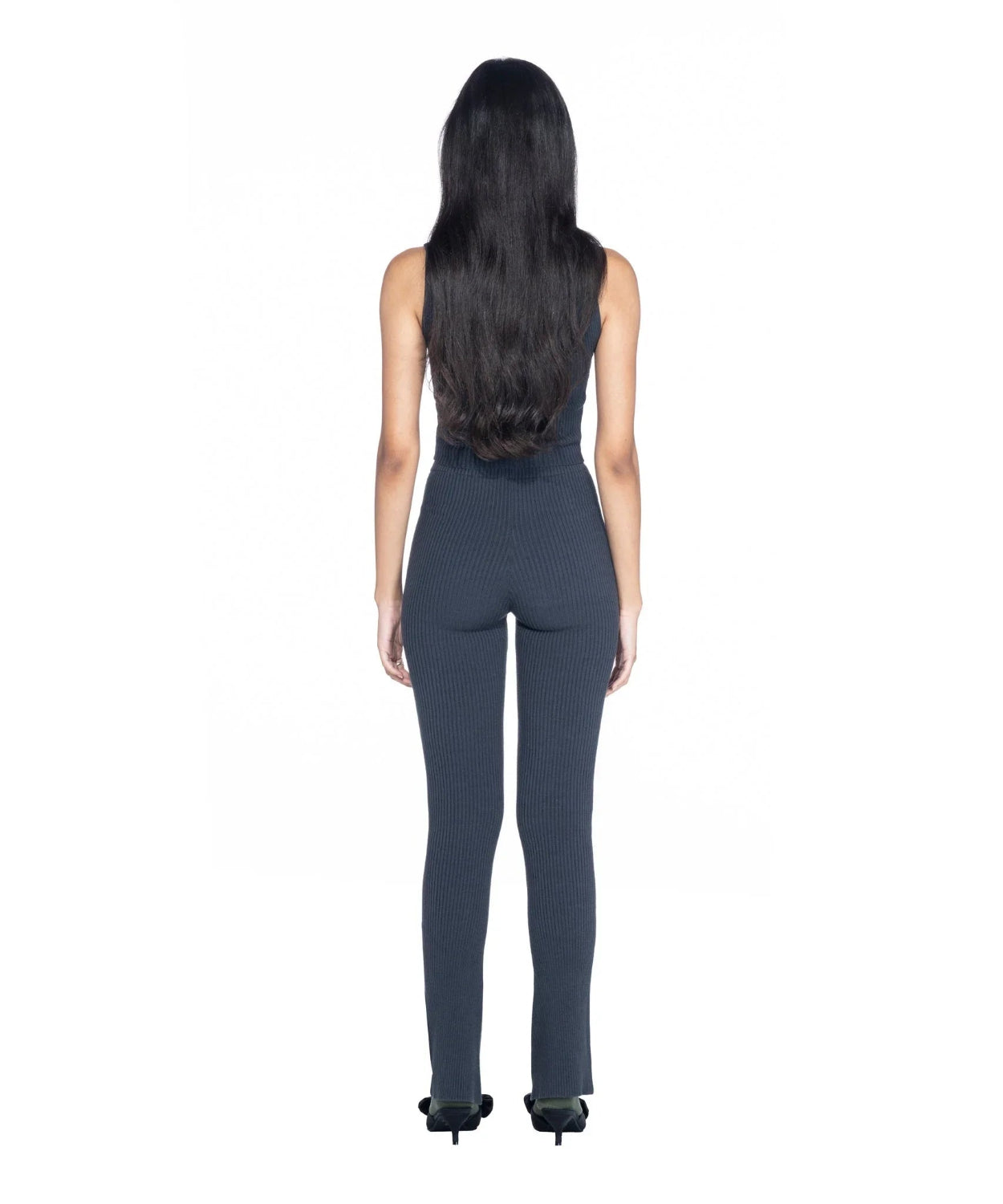Woman wearing charcoal ribbed cropped tank top and matching ribbed pants, back view