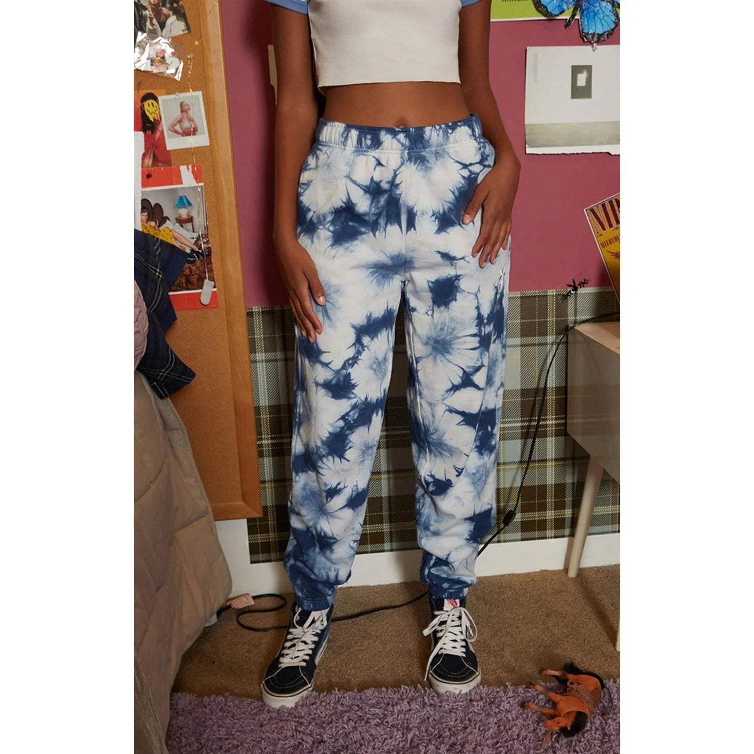 Woman wearing blue and white crystal tie-dye sweatpants in casual room setting