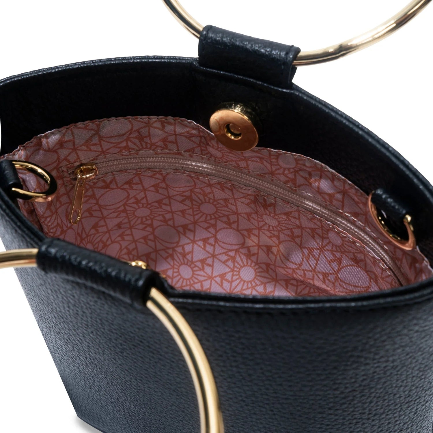 Close-up of black leather women's ring clutch with gold handles and pink patterned lining