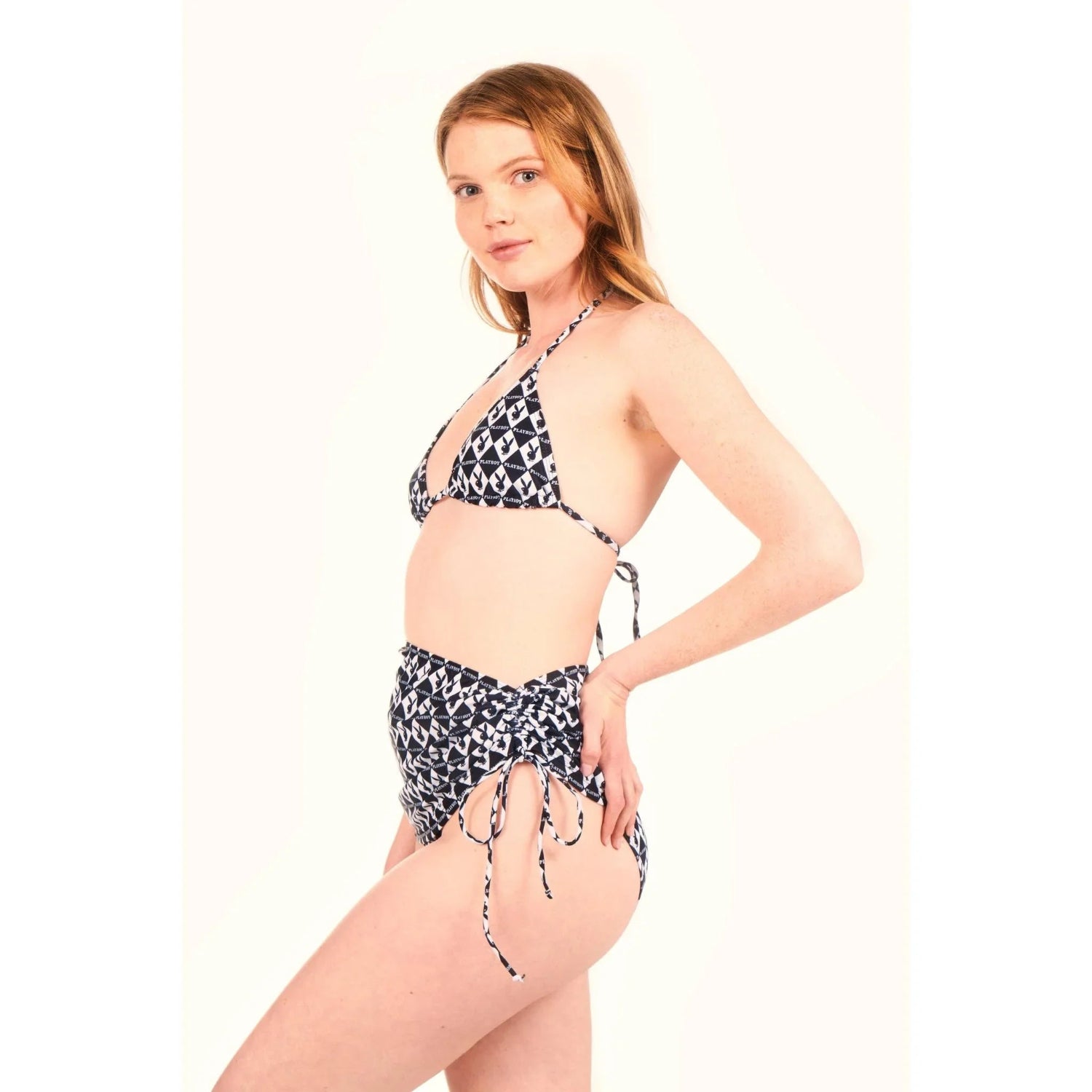 Woman wearing black and white monogram bikini and mini sarong with side ties