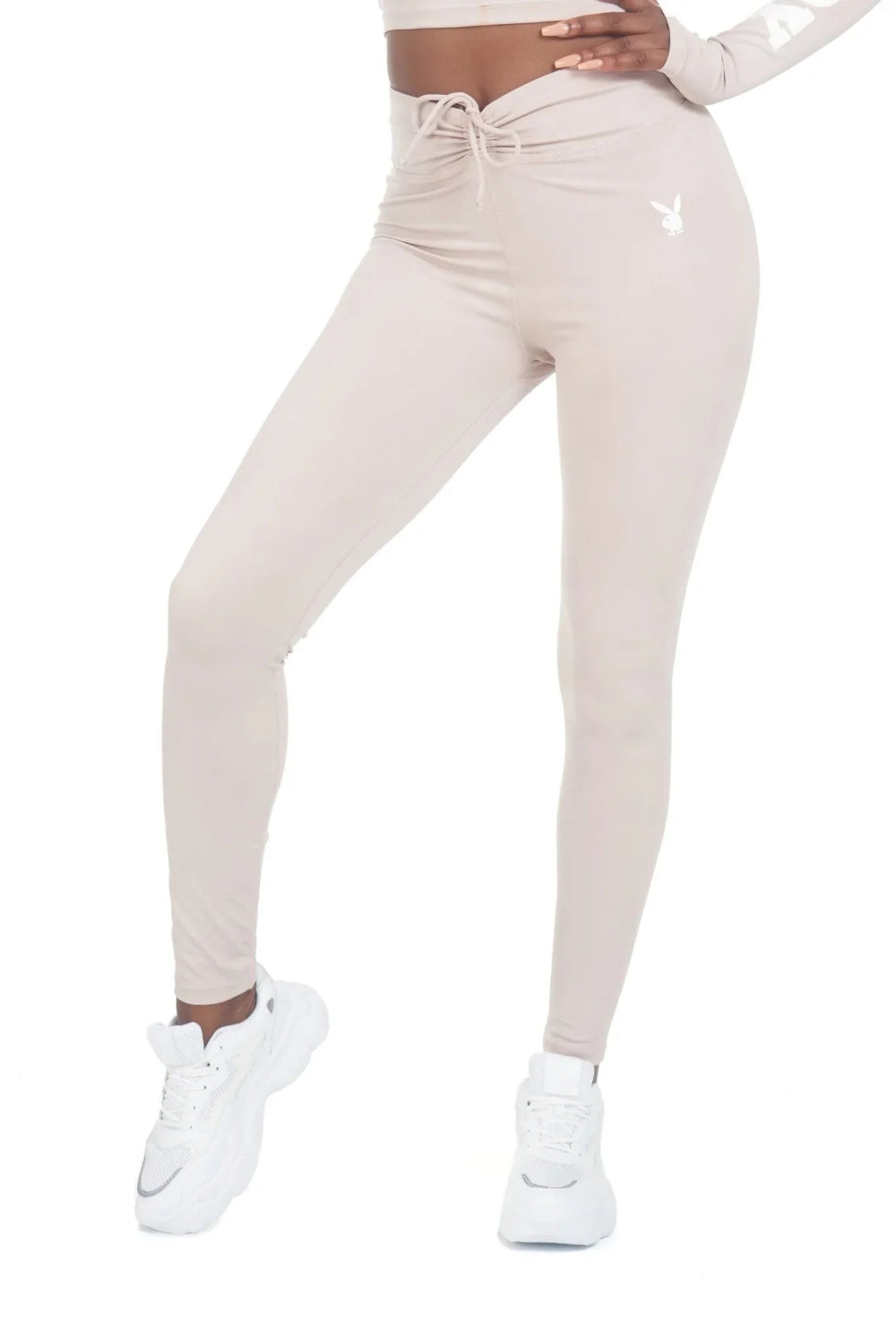 Women's beige high-waisted active leggings with ruched waistband and bunny logo